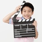 Happy  Boy Holding Clapper Board